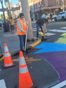 Sophia in Jersey City in October 2023 installing a temporary curb bump out!