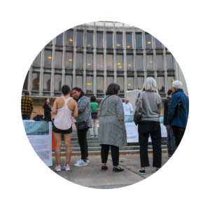 People outside talk next to the Roundhouse