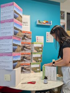 Gluing printed images on boxes for an activity at an open house