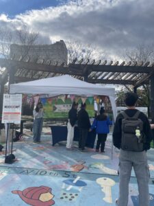 staff members are engaging with community members and talking to them about the project